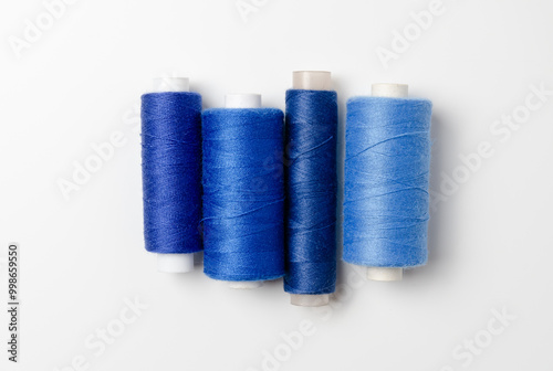 Blue thread spools on white background.