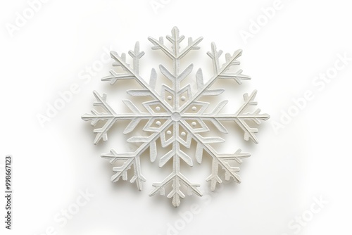 Delicate white snowflake ornament on snowy background with space for text, adding holiday magic to a serene scene. Perfect for winter wonder