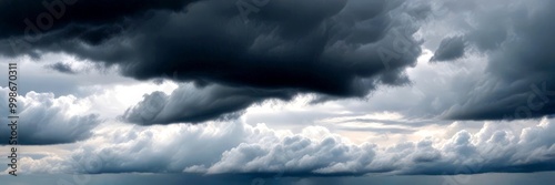 A dramatic sky filled with dark, ominous clouds looms over the horizon, creating a sense of foreboding and anticipation