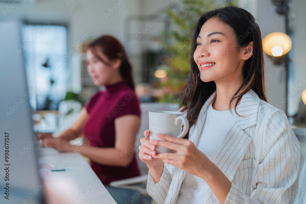 casual relax working in office smiling peaceful asian business woman chill cosy after finish project work while sit at working desk office interior design background business routine workspace