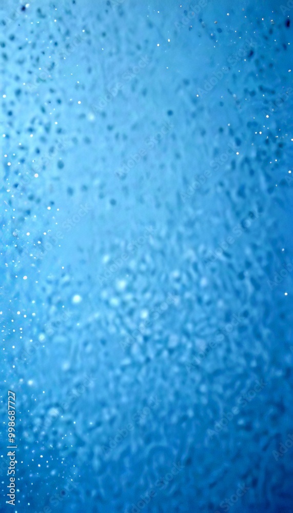 a close-up view textured surface, possibly a glass or a window, with a blue-green hue and small white specks scattered across it