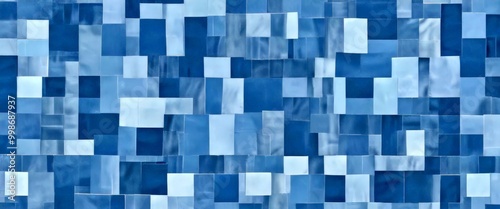 a digital collage composed of numerous small square tiles in various shades of blue, arranged in a grid-like pattern photo