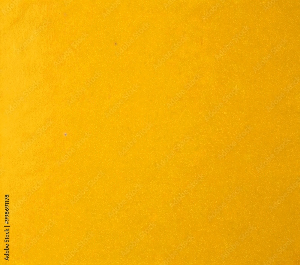 A simple, unadorned yellow background with a subtle texture A simple, unadorned yellow background with a subtle texture