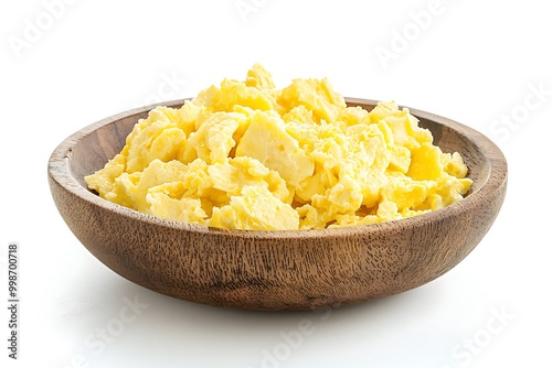 side view of scrambled egg in wooden bowl