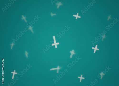 a blurred pattern of white crosses against a teal background