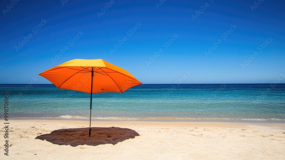 An umbrella opened on a sandy beach, providing shade on a bright sunny day with a clear blue sky. An umbrella opened on a sandy beach, providing shade on a bright sunny day with a clear blue sky.