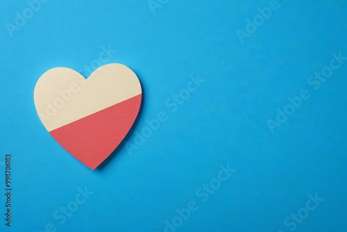 a close up of a heart shaped paper on a blue background