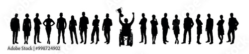 Handicapped man in wheelchair holding winning trophy among large group of people standing in row silhouette.