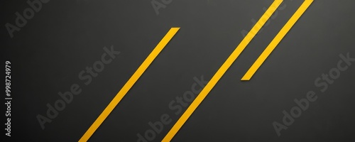 a dark gray background with two diagonal yellow lines intersecting at a right angle, creating a sense of depth and perspective photo