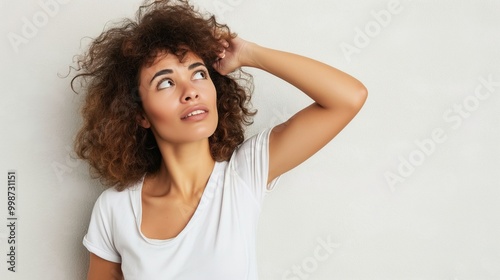 Frustrated consumer holding head, staring at blank wall with confused expression, isolated on neutral background, conveying consumer frustration and confusion.