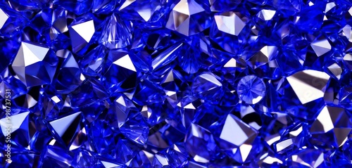 A close-up view collection of faceted, faceted, and faceted diamonds in various shades of blue, set against a dark background