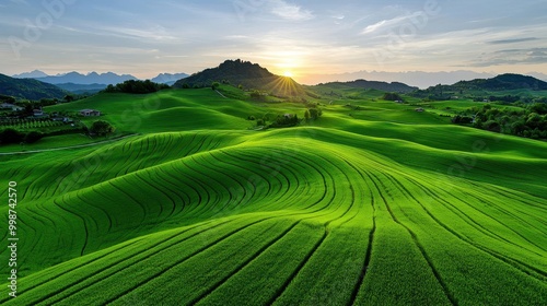 A tranquil countryside scene with rolling hills illuminated by the warm light of the setting sun