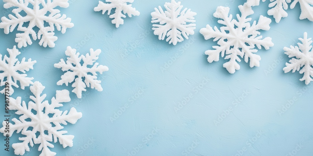 A serene blue background with white snowflakes scattered artistically, creating a winter-themed ambiance. A serene blue background with white snowflakes scattered artistically, creating a winter-themed ambiance.