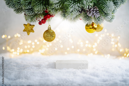 Christmas Holiday background with snow, fir tree and decorations with christmas light behind. Christmas podium for product demonstration on a winter festive background.