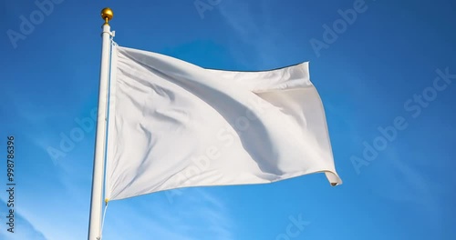 white peace flag flying with blue sky background