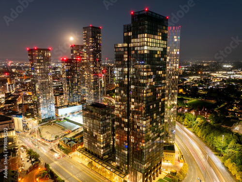 Aerial image of Manchester skyline with a full Moon over the night sky