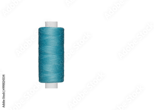 blue spool of sewing thread isolated on white background close up photo