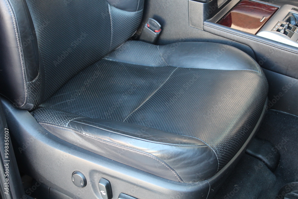 Obraz premium Leather SUV seat with electric adjustments. Electric driver seat buttons. Button for adjusting the car electric seat. Lux car leather driver seat. Black leather car interior.