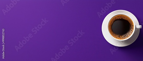 Purple background with a cup of coffee on a saucer Cup contains coffee, saucer is below Black spot present in the center of the cup
