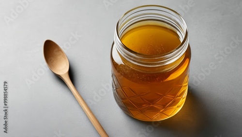  Aromatic blend of golden elixir in a glass jar photo