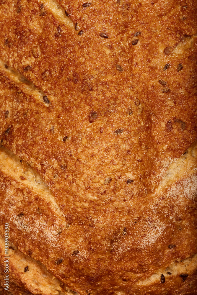 Freshly baked artisan bread with a golden crust and seeded texture displayed Freshly baked artisan bread with a golden crust and seeded texture displayed