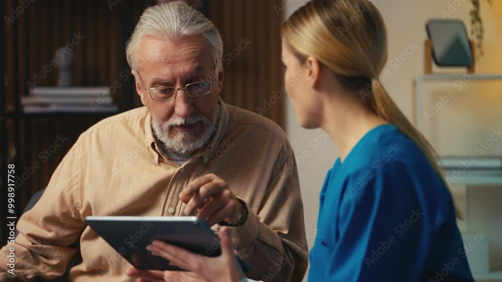 Caregiver helping senior man to create account on social media using tablet app