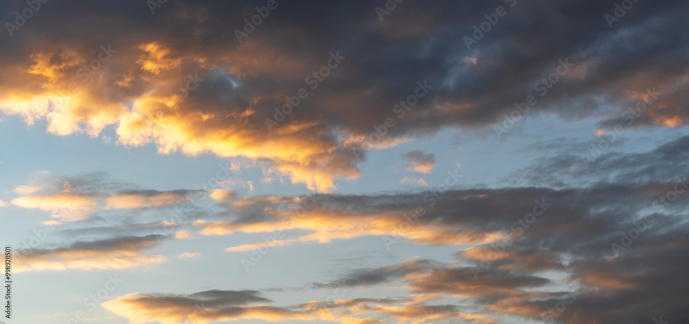 Fototapeta premium Sky background. Bright evening sunset sky with dramatic clouds.