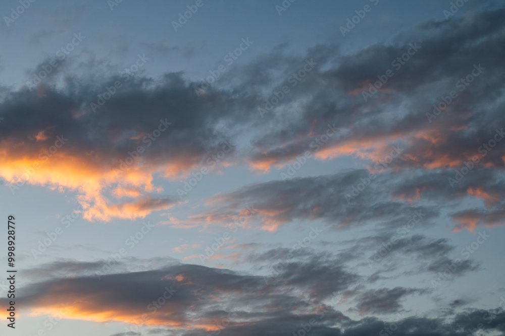 Fototapeta premium Sky background. Bright evening sunset sky with dramatic clouds.