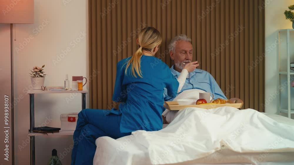 Upset senior male patient refusing to eat breakfast brought by nurse, care Upset senior male patient refusing to eat breakfast brought by nurse, care