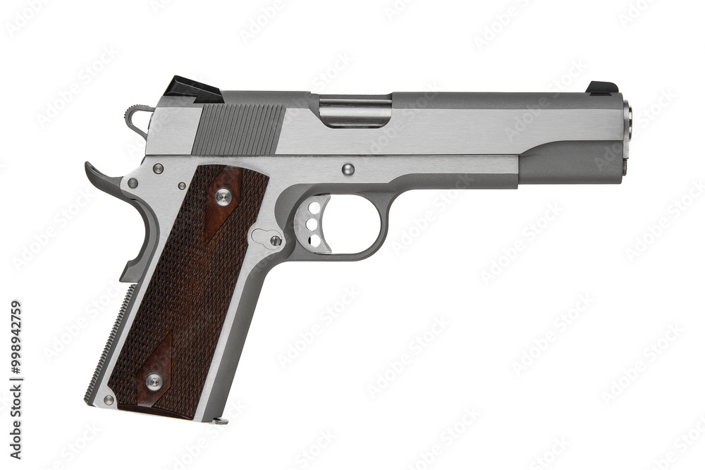 Silver pistol with a wooden handle. Short-barreled weapon. Modern semi-automatic pistol isolate on a white back Silver pistol with a wooden handle. Short-barreled weapon. Modern semi-automatic pistol isolate on a white back