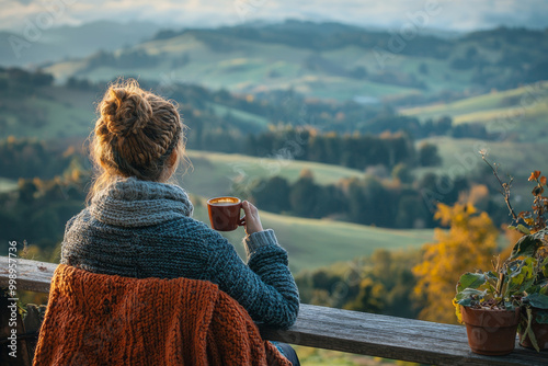 A person sipping coffee on porch overlooking scenic landscape, surrounded by natures beauty. warm colors of autumn create cozy atmosphere