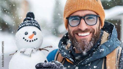 A joyful image capturing a person in a winter setting, holding a charming snowman under snowfall, highlighting the beauty and fun of winter activities and holiday spirit.