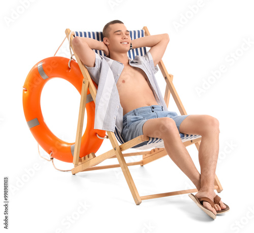 Teenage boy in deck chair o...