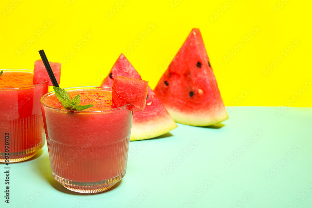 Glasses of tasty watermelon juice with mint on colorful background Glasses of tasty watermelon juice with mint on colorful background