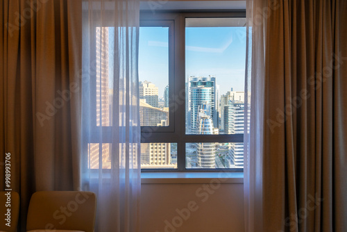 Photography view through bedroom window to cityscape with modern new buildings, Dubai, Unite