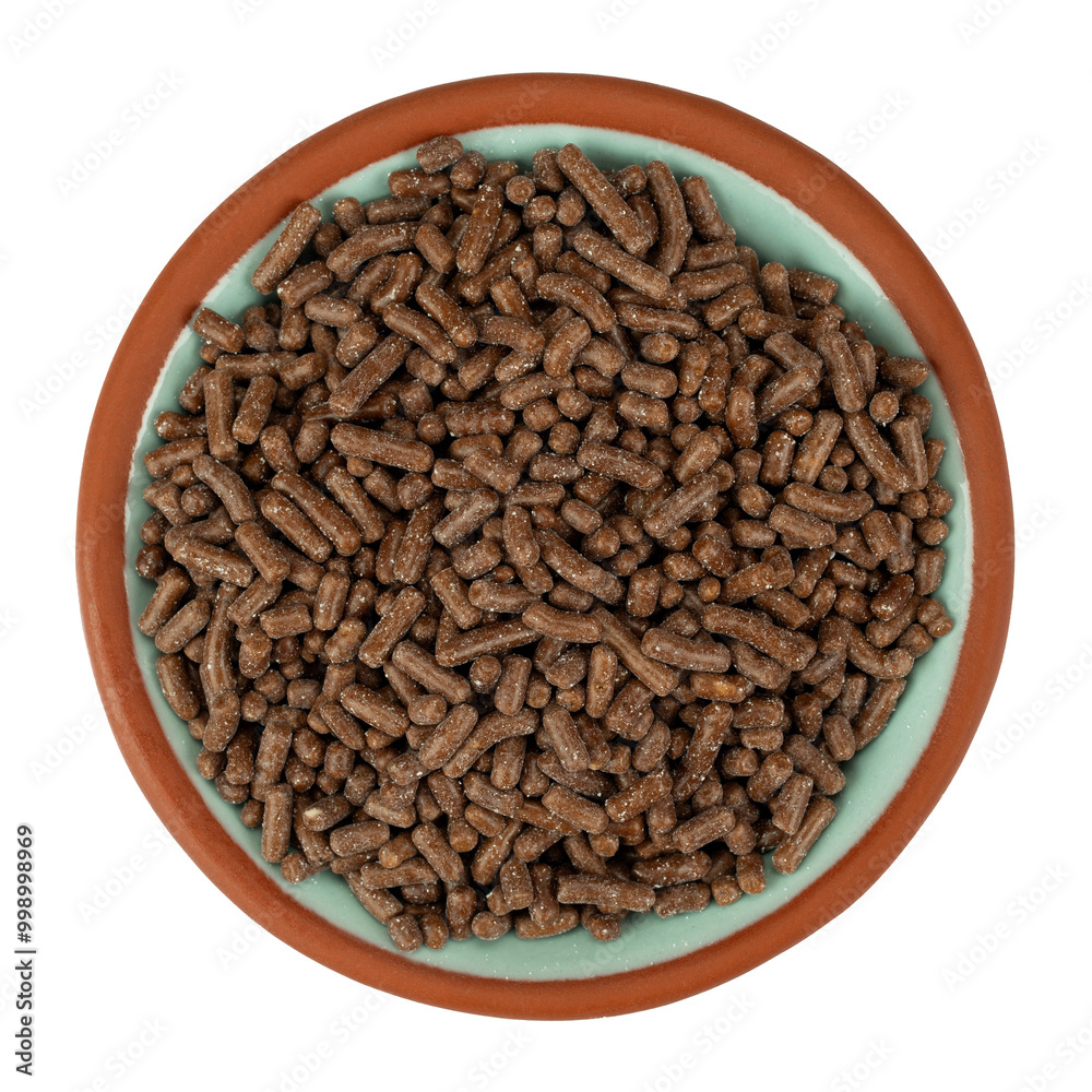 Overhead view of chocolate sprinkles in a small bowl on a white background. Overhead view of chocolate sprinkles in a small bowl on a white background.