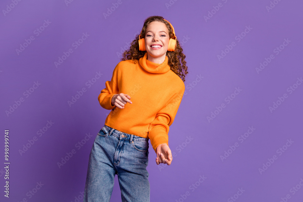 Photo of nice young girl dance headphones wear pullover isolated on violet color background Photo of nice young girl dance headphones wear pullover isolated on violet color background