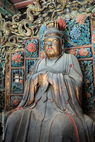 Colored Buddhist statues in the Hanging Temple of Shanxi, China, ancient Chinese cultural relics, lifelike and vividly realistic. photo