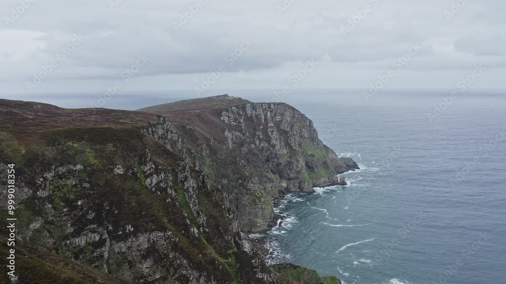 Experience breathtaking aerial views of the dramatic cliffs and serene waters in County Donegal, showcasing the natural beauty of Ireland's coastline. Experience breathtaking aerial views of the dramatic cliffs and serene waters in County Donegal, showcasing the natural beauty of Ireland's coastline.