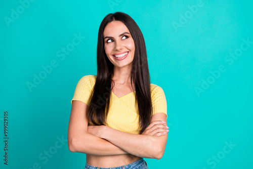 Photo of pretty young woman folded arms look empty space wear top isolated on teal color background