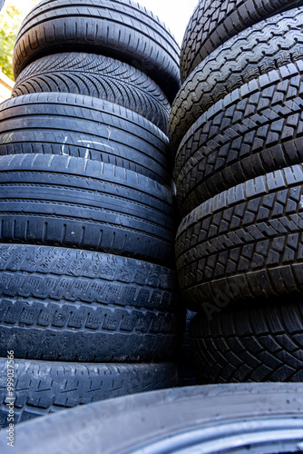 Obraz na płótnie Stack of old, worn and damaged tires lying in a landfill. Decreased road safety and environmental pollution from rubber waste w salonie