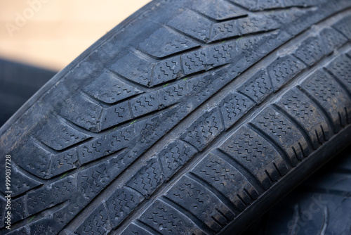 Obraz na płótnie Worn and damaged tread of old tires lying in a landfill. Decreased road safety and environmental pollution from rubber waste w salonie