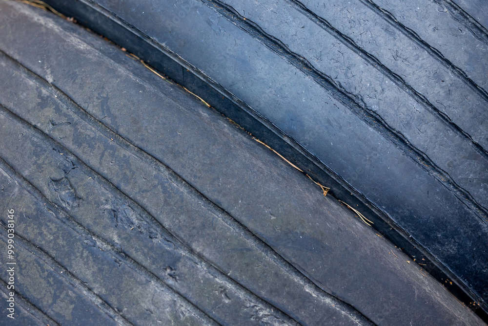 Worn and damaged tread of old tires lying in a landfill. Decreased road safety and environmental pollution from rubber waste