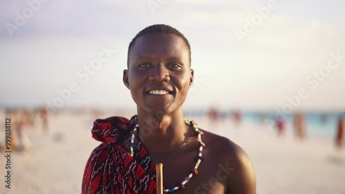 Portrait of Maasai man, traditional outfit, African warrior tribesman on beach. Tropical island beach in Tanzania. tourism destination in Africa. 