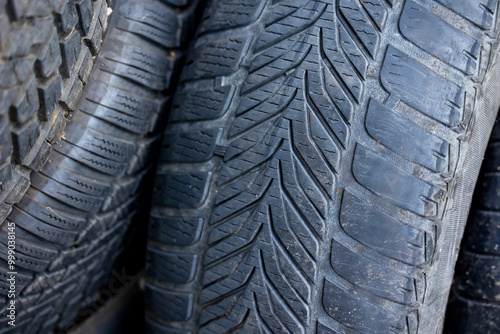 Obraz na płótnie Worn and damaged tread of old tires lying in a landfill. Decreased road safety and environmental pollution from rubber waste w salonie
