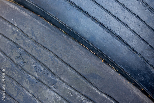 Obraz na płótnie Worn and damaged tread of old tires lying in a landfill. Decreased road safety and environmental pollution from rubber waste w salonie