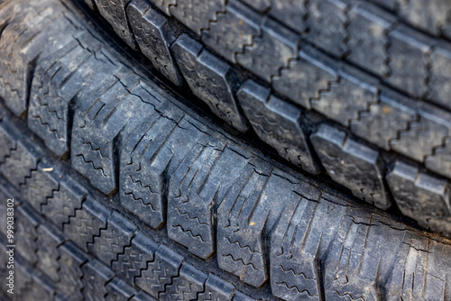 Obraz na płótnie Worn and damaged tread of old tires lying in a landfill. Decreased road safety and environmental pollution from rubber waste w salonie
