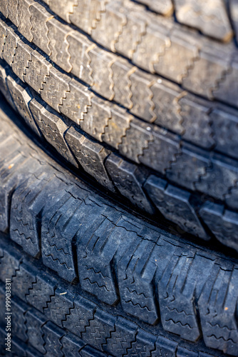 Obraz na płótnie Worn and damaged tread of old tires lying in a landfill. Decreased road safety and environmental pollution from rubber waste w salonie
