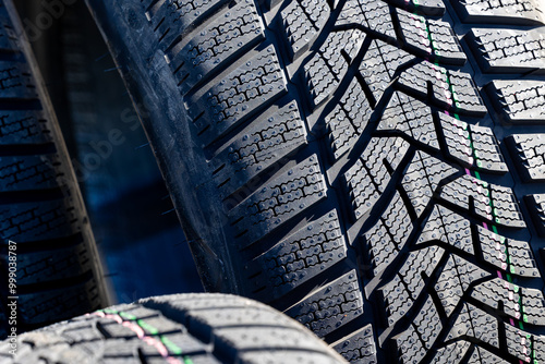 Obraz na płótnie Sharp tread of new winter tires ready for the seasonal change. New tires are important for increasing road safety w salonie