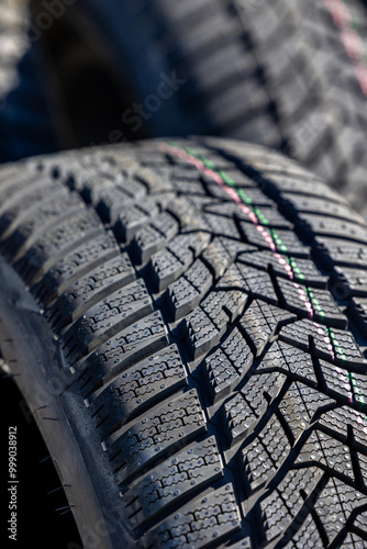 Obraz na płótnie Sharp tread of new winter tires ready for the seasonal change. New tires are important for increasing road safety w salonie